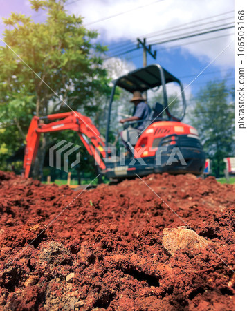 Soil close up blurred backhoe to renovate the site in preparation for pouring the concrete slab 106503168