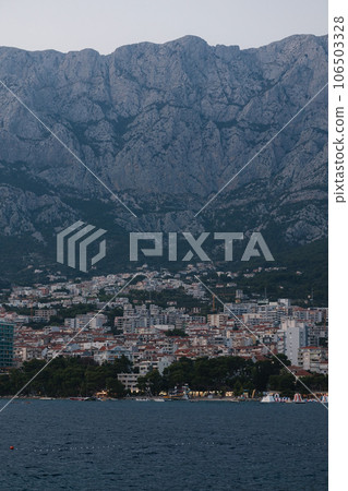 Midnight photo of city under the mountain. Beautiful landscape of sea and city 106503328