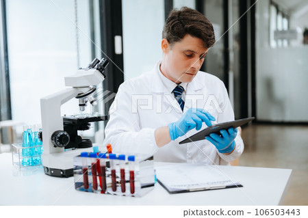 Modern medical research laboratory. female scientist working with micro pipettes analyzing biochemical samples, advanced science chemical laboratory . 106503443
