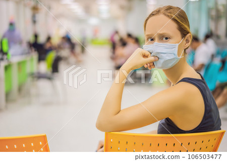 Young woman sitting in hospital waiting for a doctor's appointment. Patients In Doctors Waiting Room Young woman sitting in hospital waiting for a doctor's appointment. Patients In Doctors Waiting Room 106503477