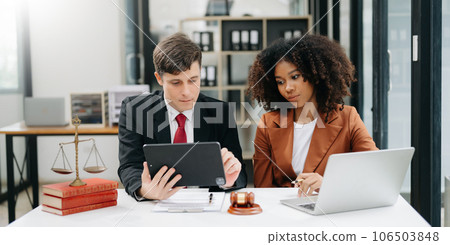 business people and lawyers discussing contract papers sitting at the table. Concepts of law, advice, legal services. in morning light. business people and lawyers discussing contract papers sitting at the table. Concepts of law, advice, legal services. in morning light. 106503848