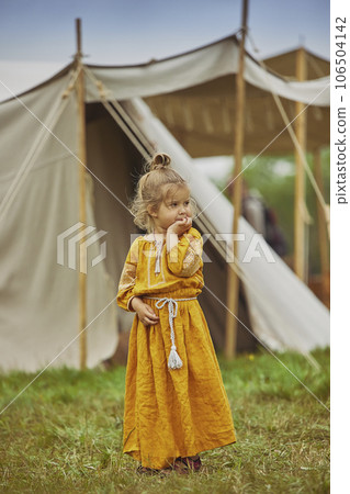 Charming child in embroidered dress at the viking festival in Denmark Charming child in embroidered dress at the viking festival in Denmark 106504142