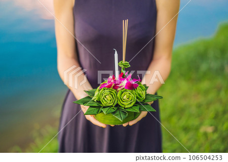 Young woman celebrates Loy Krathong, Runs on the water. Loy Krathong festival, People buy flowers and candle to light and float on water to celebrate the Loy Krathong festival in Thailand 106504253