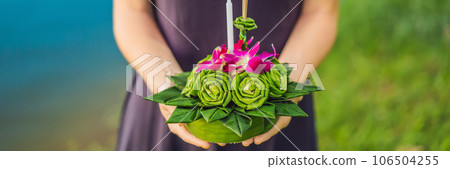 Young woman celebrates Loy Krathong, Runs on the water. Loy Krathong festival, People buy flowers and candle to light and float on water to celebrate the Loy Krathong festival in Thailand BANNER, LONG Young woman celebrates Loy Krathong, Runs on the water. Loy Krathong festival, People buy flowers and candle to light and float on water to celebrate the Loy Krathong festival in Thailand BANNER, LONG 106504255