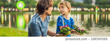 Father and son tourists celebrates Loy Krathong, Runs on the water. Loy Krathong festival, People buy flowers and candle to light and float on water to celebrate the Loy Krathong festival in Thailand 106504369