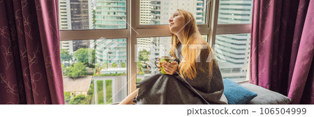 Woman wrapped in a blanket and looking at the big city BANNER, LONG FORMAT Woman wrapped in a blanket and looking at the big city BANNER, LONG FORMAT 106504999
