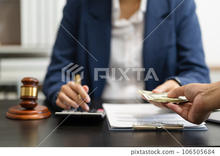 Lawyer or accounting department writes a note and uses a calculator to calculate expenses - income. at office lawyer. Lawyer or accounting department writes a note and uses a calculator to calculate expenses - income. at office lawyer. 106505684