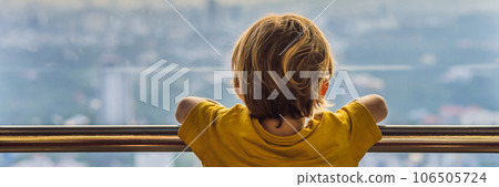 Little boy looks at Kuala lumpur cityscape. Panoramic view of Kuala Lumpur city skyline evening at sunset skyscrapers building in Malaysia. Traveling with kids concept BANNER, LONG FORMAT Little boy looks at Kuala lumpur cityscape. Panoramic view of Kuala Lumpur city skyline evening at sunset skyscrapers building in Malaysia. Traveling with kids concept BANNER, LONG FORMAT 106505724