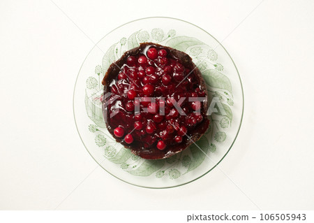 chocolate dessert with berry jam on a white plate, top view chocolate dessert with berry jam on a white plate, top view 106505943