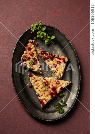 delicious crumble with lingonberry jam on a dark tray 106506018