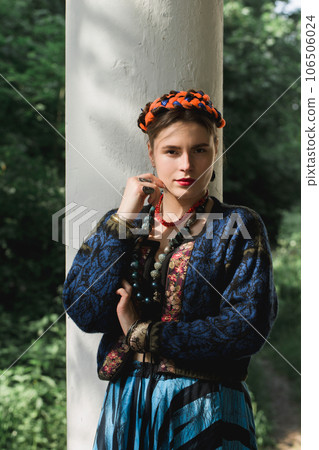 Beautiful young woman with braids on her head and a necklace Beautiful young woman with braids on her head and a necklace 106506024