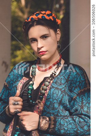 Beautiful young woman with braids on her head and a necklace, tinted Beautiful young woman with braids on her head and a necklace, tinted 106506026
