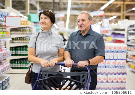 Elderly couple walks through the supermarket Elderly couple walks through the supermarket 106506611