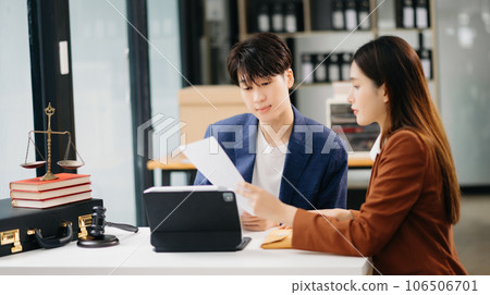 Asian business team and lawyers discussing contract papers sitting at the table. Concepts of law, advice, legal services. at office 106506701