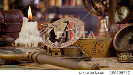 Vintage style travel and adventure. Vintage old compass and other vintage items on the table. Vintage style travel and adventure. Vintage old compass and other vintage items on the table. 106506797