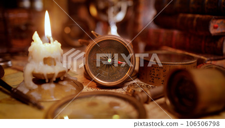 Vintage style travel and adventure. Vintage old compass and other vintage items on the table. Vintage style travel and adventure. Vintage old compass and other vintage items on the table. 106506798