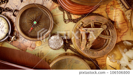 Vintage style travel and adventure. Vintage old compass and other vintage items on the table. Vintage style travel and adventure. Vintage old compass and other vintage items on the table. 106506800