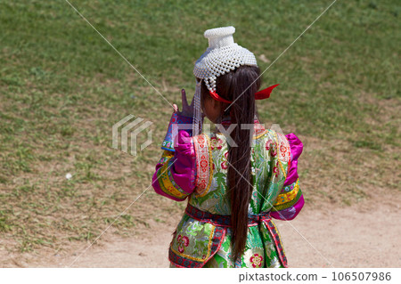 Girl in traditional clothes in front of Erdene Zuu Monastery in Kharkhorin Girl in traditional clothes in front of Erdene Zuu Monastery in Kharkhorin 106507986