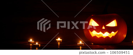 Three Halloween Pumpkins and candles 106509451