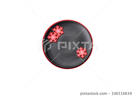 Empty ceramic black plate with christmas decoration elements Empty ceramic black plate with christmas decoration elements 106510639