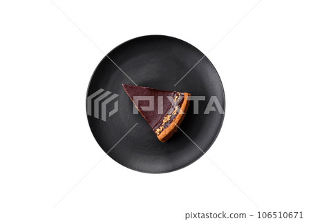 Delicious, fresh, sweet chocolate cake with nuts cut into slices 106510671