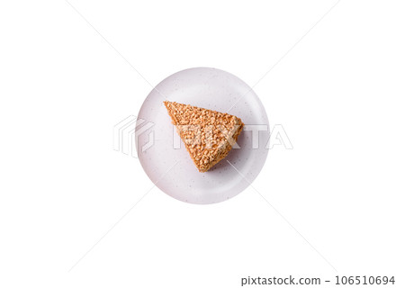Delicious sweet puff waffle cake with cream and nuts cut into pieces 106510694