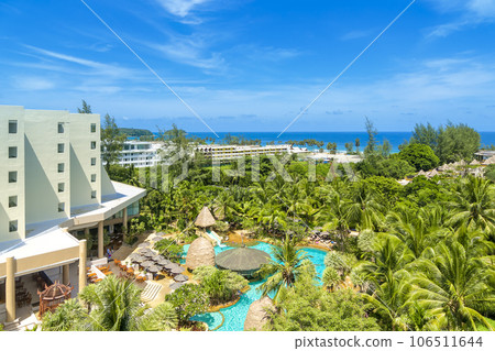 View of the blue sea and palm trees of Karon Beach on Phuket Island, Thailand from a resort hotel View of the blue sea and palm trees of Karon Beach on Phuket Island, Thailand from a resort hotel 106511644