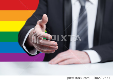 Businessman hand in suit, handshake on the background of LGBT flag. Partnership, equality conept 106512455