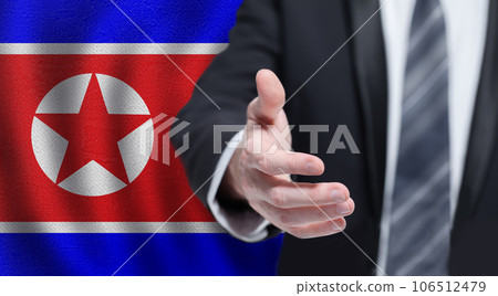 North Korea politics concept. Hand on flag of North Korea background. North Korea politics concept. Hand on flag of North Korea background. 106512479