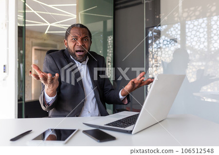Frustrated angry boss looking at camera, senior gray haired mature man shouting upset, businessman inside office unhappy with achievement results, working with laptop. Frustrated angry boss looking at camera, senior gray haired mature man shouting upset, businessman inside office unhappy with achievement results, working with laptop. 106512548
