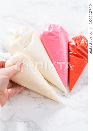 Homemade royal icing in piping bags ready to decorate sugar cookies on the kitchen counter. Homemade royal icing in piping bags ready to decorate sugar cookies on the kitchen counter. 106512749