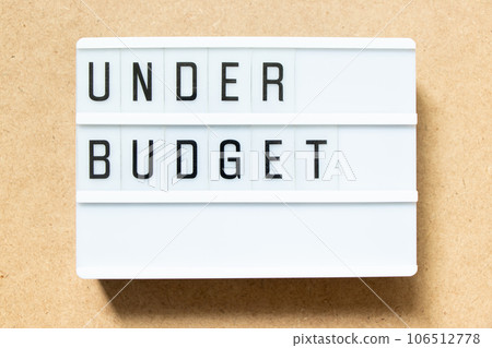 Lightbox with word under budget on wood background Lightbox with word under budget on wood background 106512778