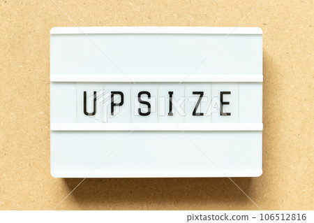 Lightbox with word upsize on wood background 106512816