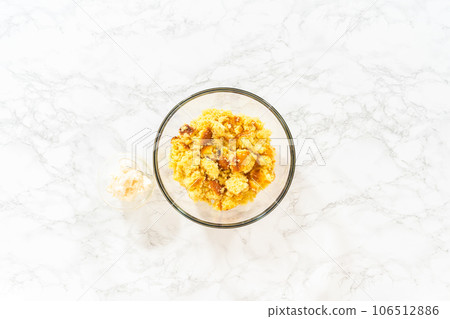 Flat lay. Mixing ingredients in a large glass mixing bowl to make cactus cake pops for the Cinco de Mayo celebration. 106512886