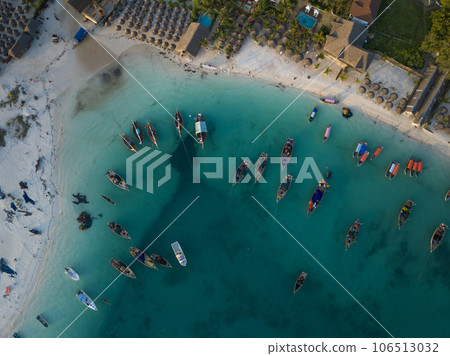 Drone view of wooden fisherman boats and sandy beach 106513032