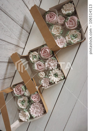 Homemade marshmallows in a paper gift box. Zephyr flowers. The boxes is open. View from above. Homemade marshmallows in a paper gift box. Zephyr flowers. The boxes is open. View from above. 106514513