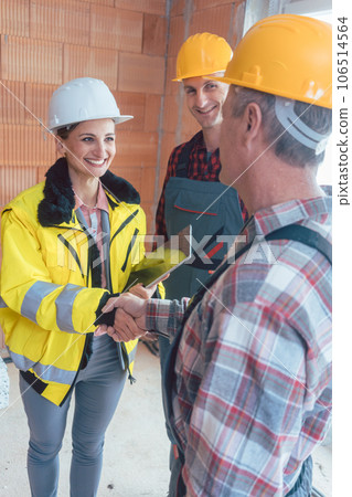 Construction engineer and worker shaking hands Construction engineer and worker shaking hands 106514564