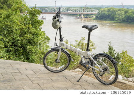 lightweight folding bike on a high shore of the Missouri River above Katy Trail overseeing bridge construction near Rocheport, MO in summer scenery lightweight folding bike on a high shore of the Missouri River above Katy Trail overseeing bridge construction near Rocheport, MO in summer scenery 106515059