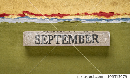 September text on grunge wooden block against handmade rag papers, calendar concept September text on grunge wooden block against handmade rag papers, calendar concept 106515079