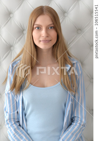 Beauty portrait. Young woman on grey wall background. 106515541