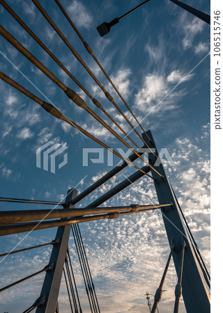 modern metal cable bridge on blue sky background at sunset, Lublin modern metal cable bridge on blue sky background at sunset, Lublin 106515746