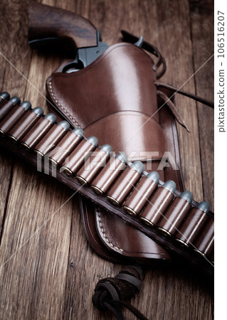 Old west leather gun belt with ammnunitions and revolver in holster Old west leather gun belt with ammnunitions and revolver in holster 106516207
