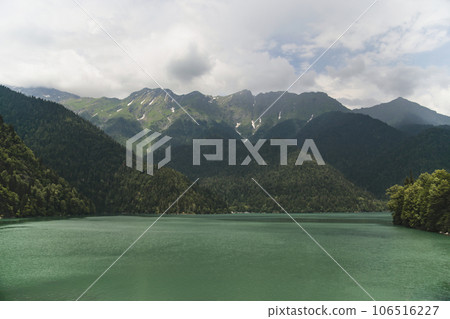 Beautiful lake in the mountains sky with clouds and mountain forest 106516227