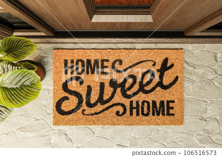 Home Sweet Home doormat on the porch at the front door. 106516573