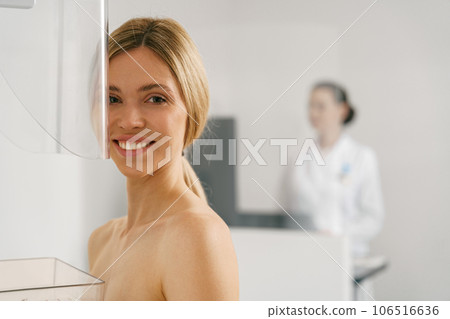 Young woman doing mammogram x ray for breast cancer prevention screening at modern hospital 106516636