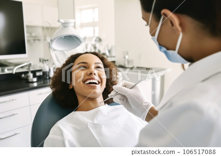 Girl sits in dental chair in doctor office, patient showing teeth 106517088