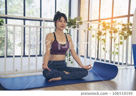 Asana yoga Beautiful woman smiling in sportswear sitting on yoga mat home fitness happy wellness lifestyle. Smiling asian woman doing asana yoga body, leg stretching in living room home fitness sport Asana yoga Beautiful woman smiling in sportswear sitting on yoga mat home fitness happy wellness lifestyle. Smiling asian woman doing asana yoga body, leg stretching in living room home fitness sport 106519195