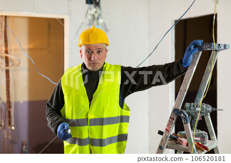 Repair man standing in apartment and looking at camera Repair man standing in apartment and looking at camera 106520181