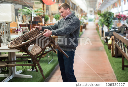 Man choosing new furniture in salon Man choosing new furniture in salon 106520227