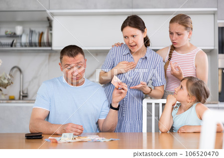 Disgruntled wife and teenage daughters demanding for money from upset man 106520470
